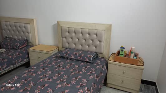 two single beds with two side tables