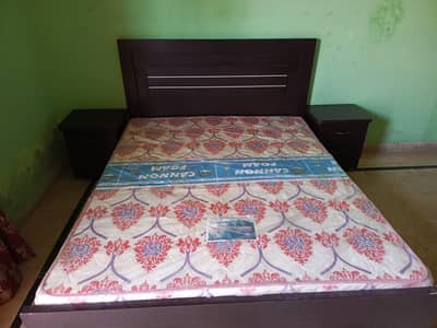 Queen size bed with cannon medical mattress and 2 side tables