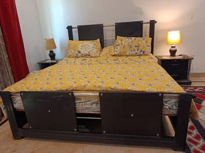 solid wood double bed with side tables and room chairs with center tab