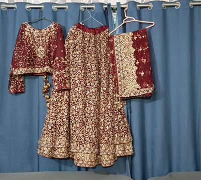Beautiful maroon bridal lehenga with heavy golden embroidery