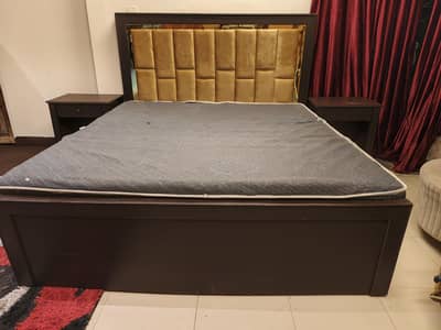 wooden bed with two side tables and dressing table