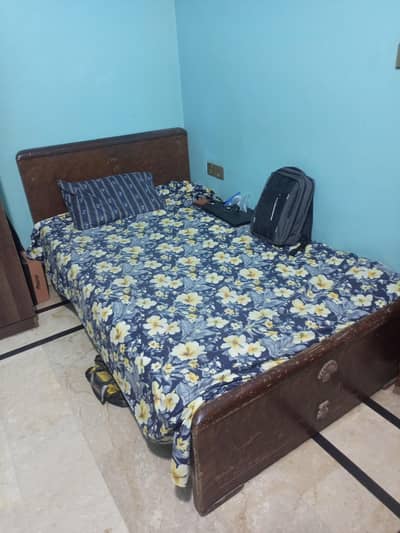 wooden single bed with mattress