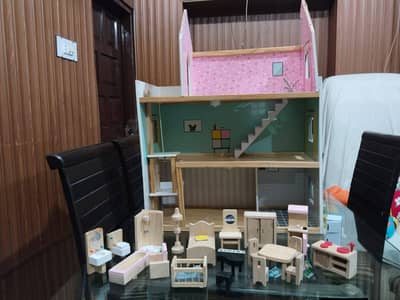 wooden doll house with wooden accessories