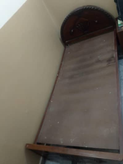 Two single beds and one wooden charpai