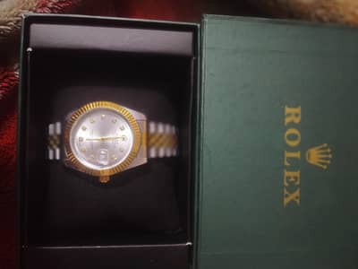 A man's watch in brand name is Rolex Oyster perpetual Date Just