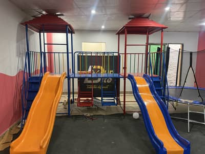 Play area for kids slides,swings and jumping castle
