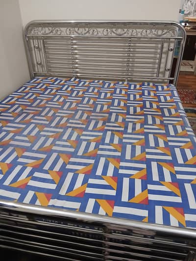 King-sized steel bed with foam.