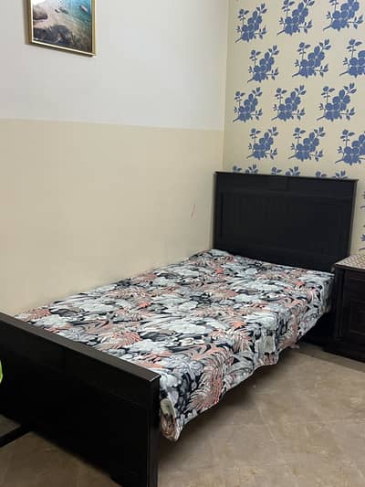 Single wooden bed without mattress