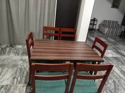 A few months used wooden dinning table and chairs
