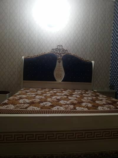 bed with side tables and dressing table