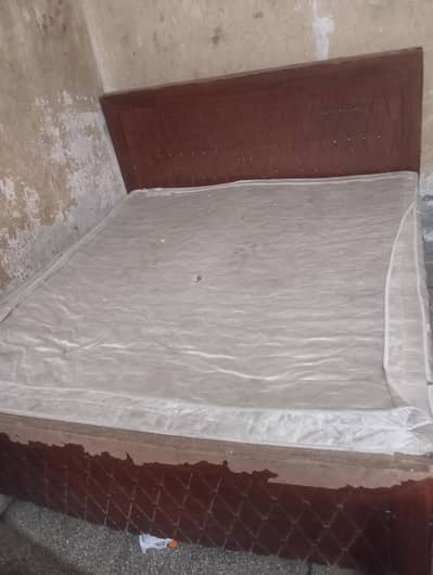 wooden bed with mattress