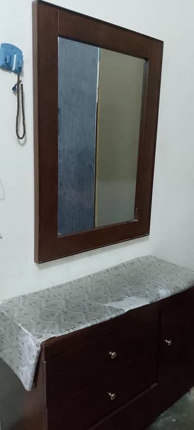 bed and dressing table with mirror