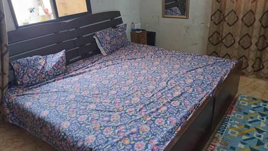 Double wooden bed with mattress