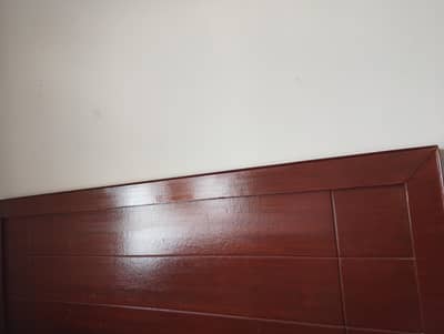 wooden bed and ironing board