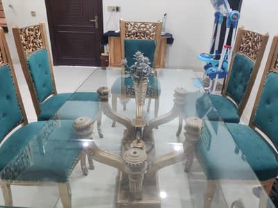 glass table with Wooden chairs