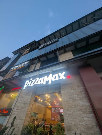 Female Cashier at Pizza Max restaurant