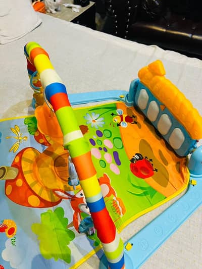 baby playing piano gym mat