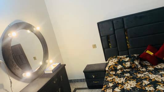 bed with side tables and dressing table
