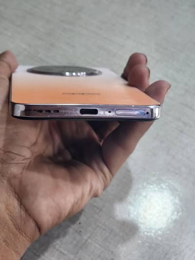 OPPO Reno12 F smartphone, likely in the Sunset Peach colorway.