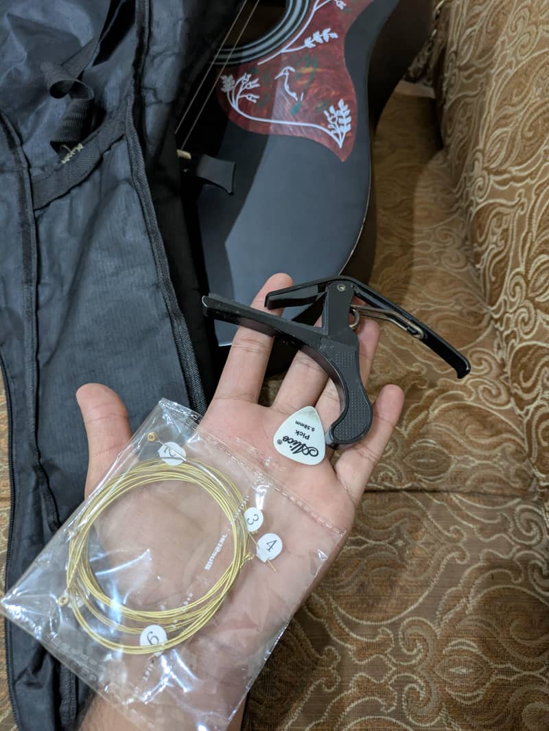 acoustic guitar with extra strings, capo,bag,pick 1