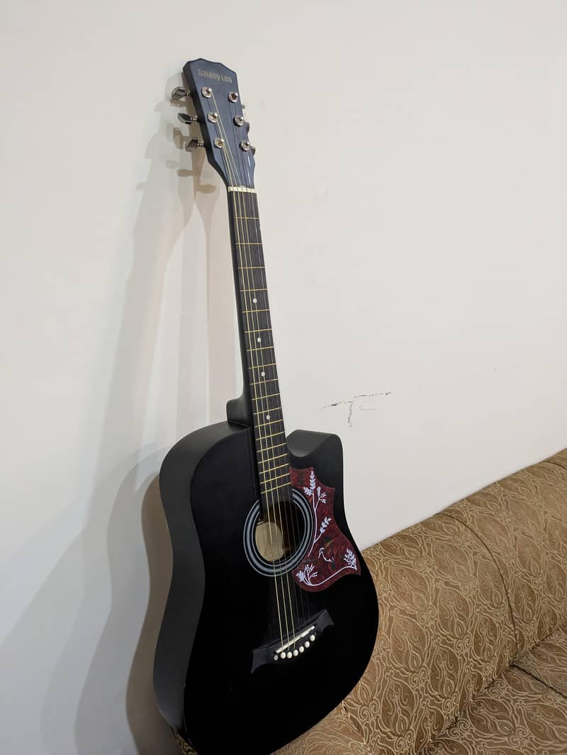 acoustic guitar with extra strings, capo,bag,pick 2