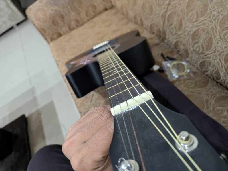 acoustic guitar with extra strings, capo,bag,pick 3