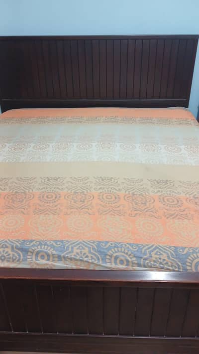 Wooden bed with mattress