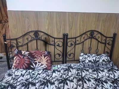 two single beds with side tables in good condition