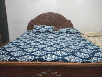 A Queen size wooden bed  without Mattress is for sale