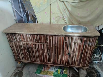 Kitchen storage cabinet with upper marble tile and sink