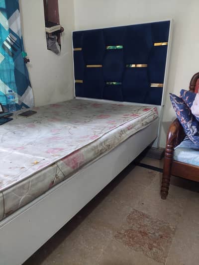 Single wooden bed with mattress