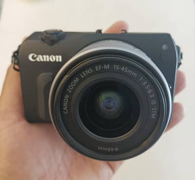 cannon M DSLR camera with original charger strap battery lens