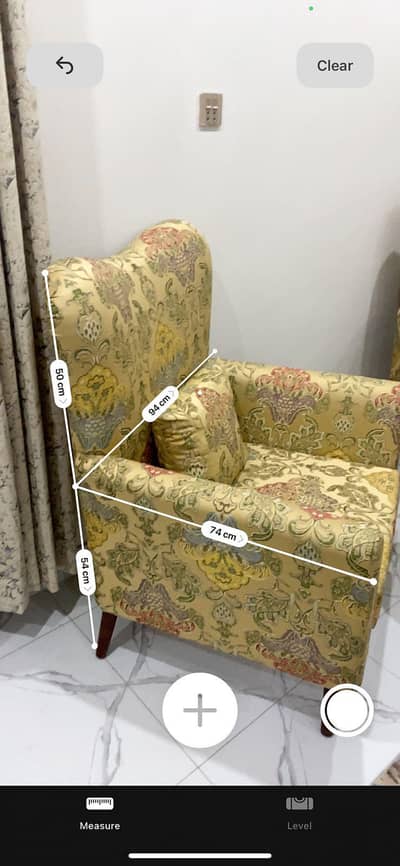 2 sofas , each 1 seater with a table and glass