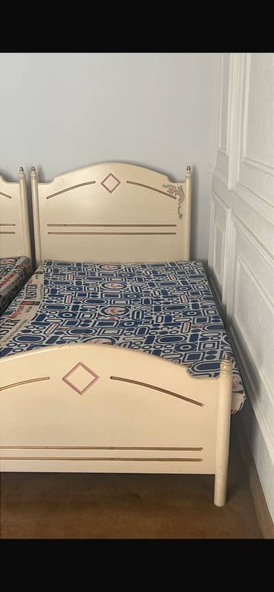 A single wooden bed without mattress