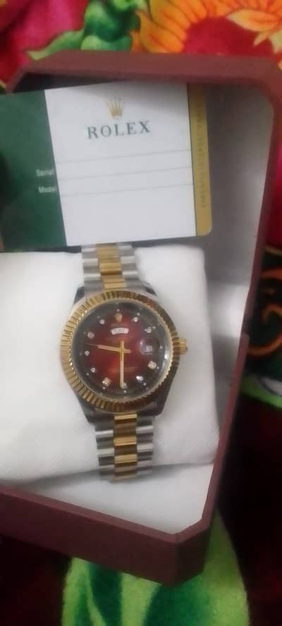 Rolex day and date watch with red dial