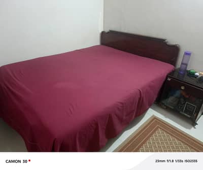 Queen bed with side table and mattes