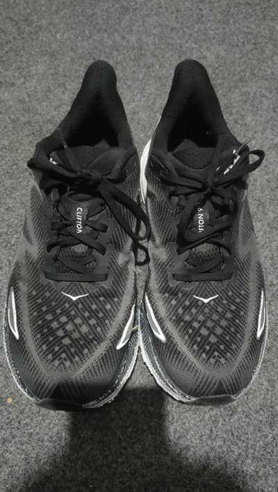 Hoka Clifton 9 running shoes in black.