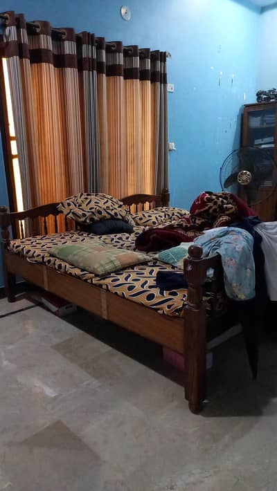 2 wooden single beds