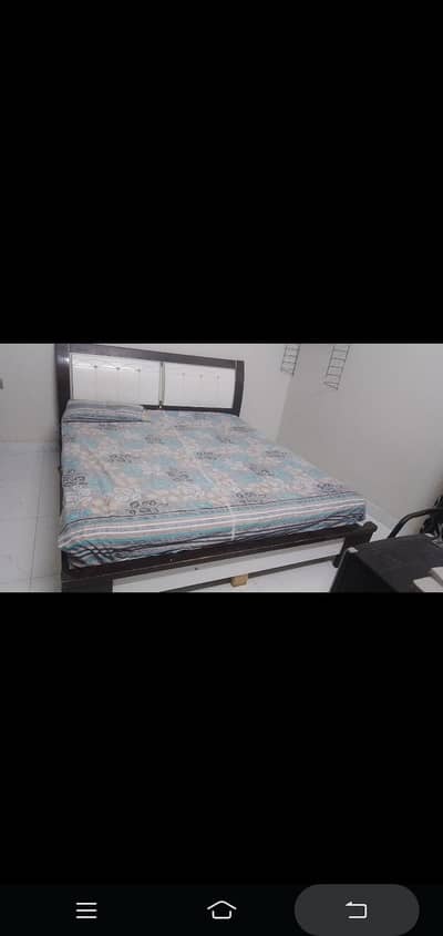 wooden bed with mattress