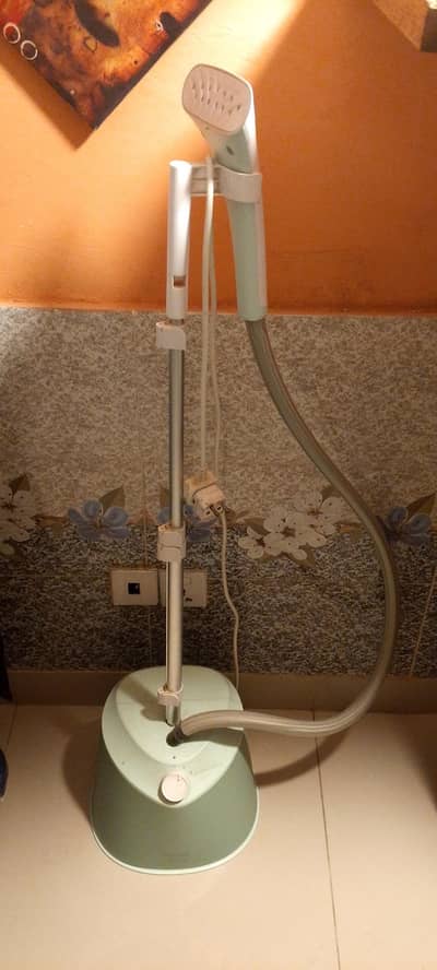 An excellent steam iron with box. . .