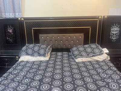 Wooden bed with two side tables without mattress