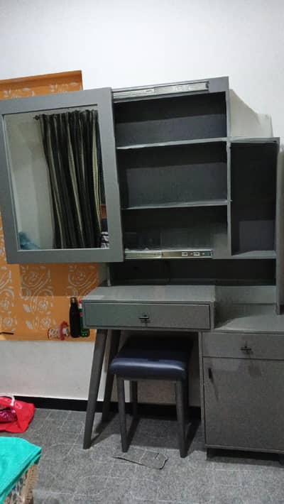 dressing table with sliding mirror and storage behind.