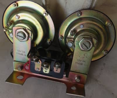 Those are dual tone electric horns the kind you'll find on cars, bikes