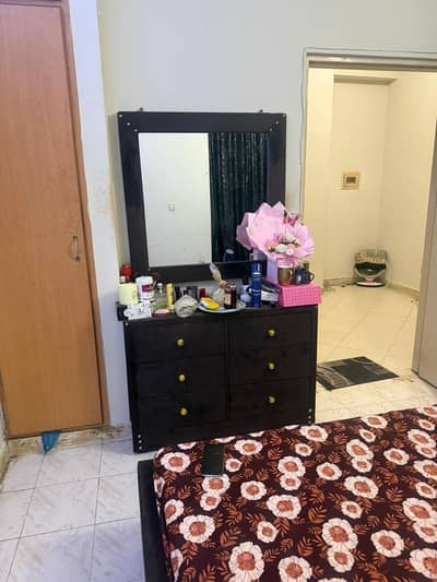 bed with mattress and dressing table