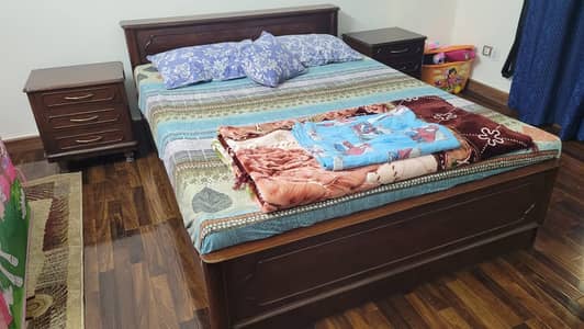 Wooden Bed with bedside tables.