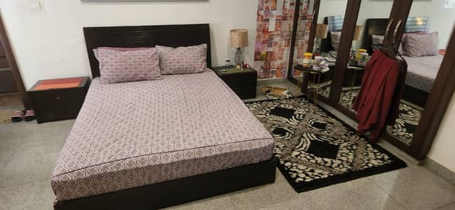 wooden queen size bed with sidetables