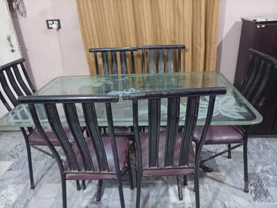 Iron rod dining table glass top with 6 chairs. No repair work needed.