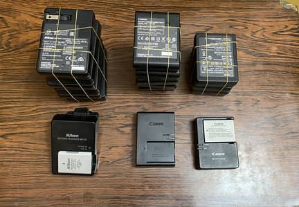 Nikon and canon dslrs batteries and chargers(100% original box pulled)