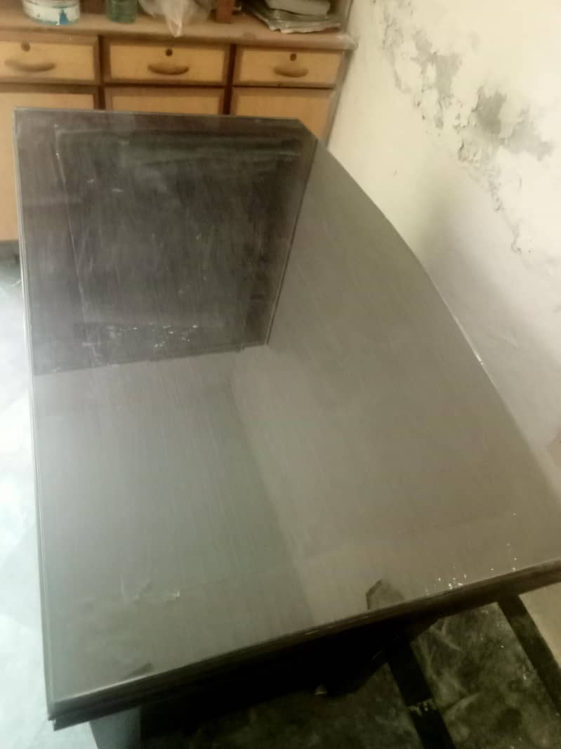 Solid office Table with clean glass on upper side. 1