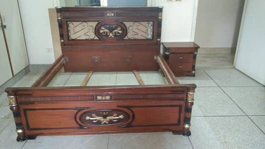 king size bed with 2 side tables and a dressing table